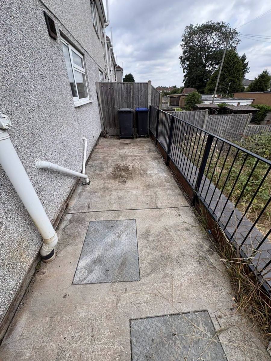 Side passage swept clean, only the bins left