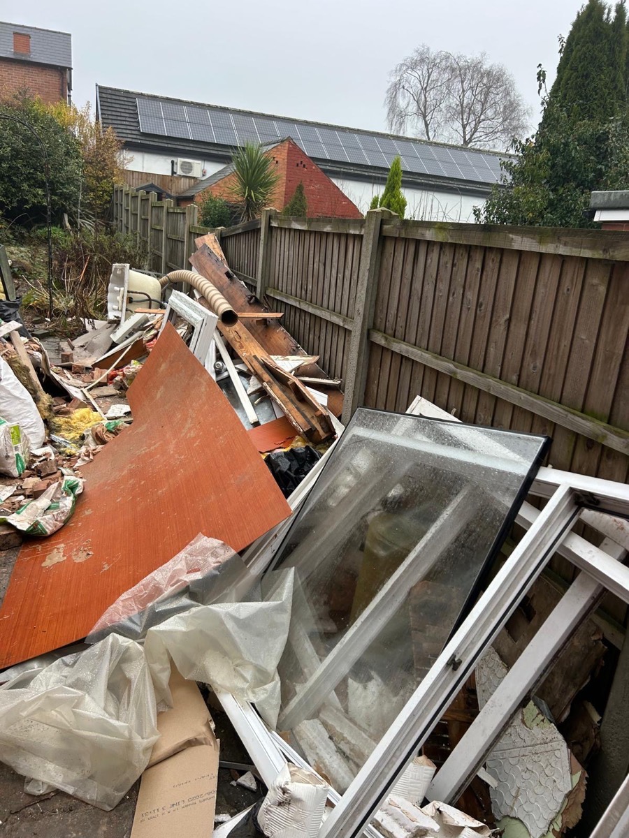 Old windows, insulation and boarding piled up for collection